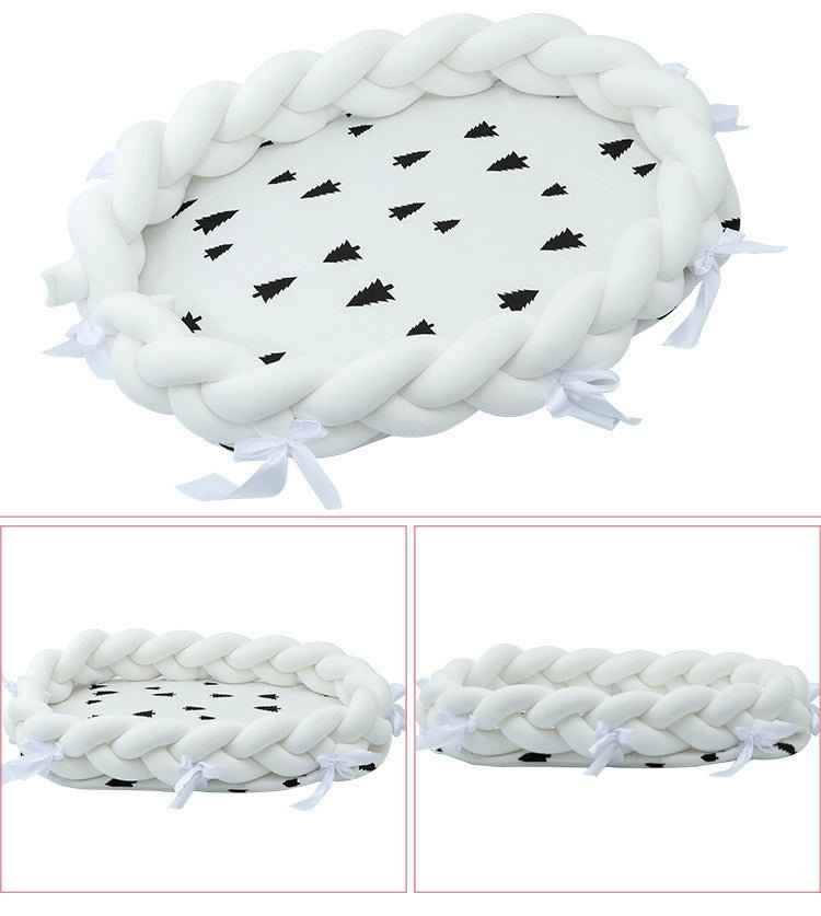 Soft sage green braided baby nest bed close-up showing fine weave texture and quality craftsmanship